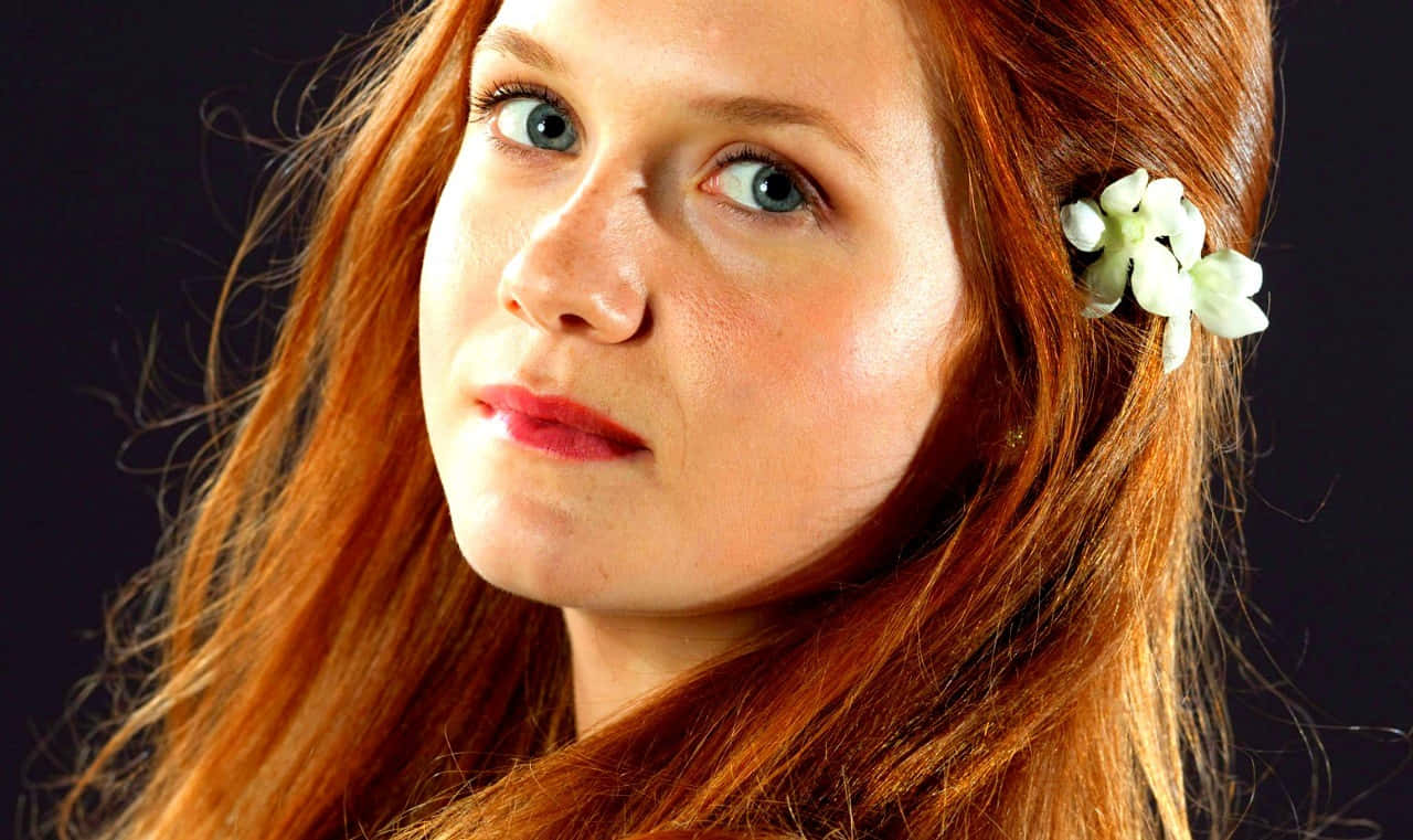 Magical Ginny Weasley In Action Wallpaper