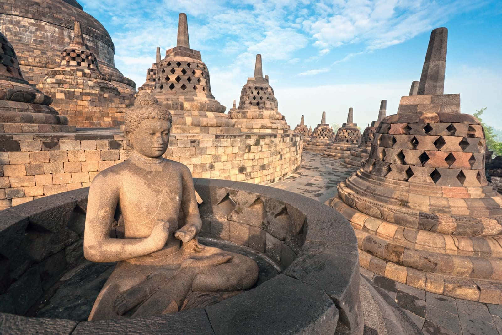 Majestic Borobudur Temple Against Vibrant Blue Sky Wallpaper