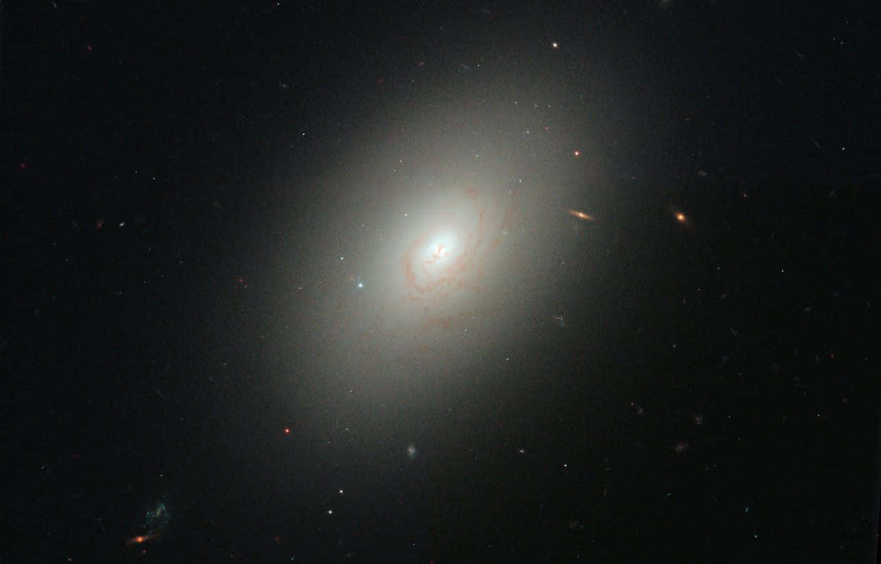 Majestic Elliptical Galaxy In The Depths Of Space Wallpaper