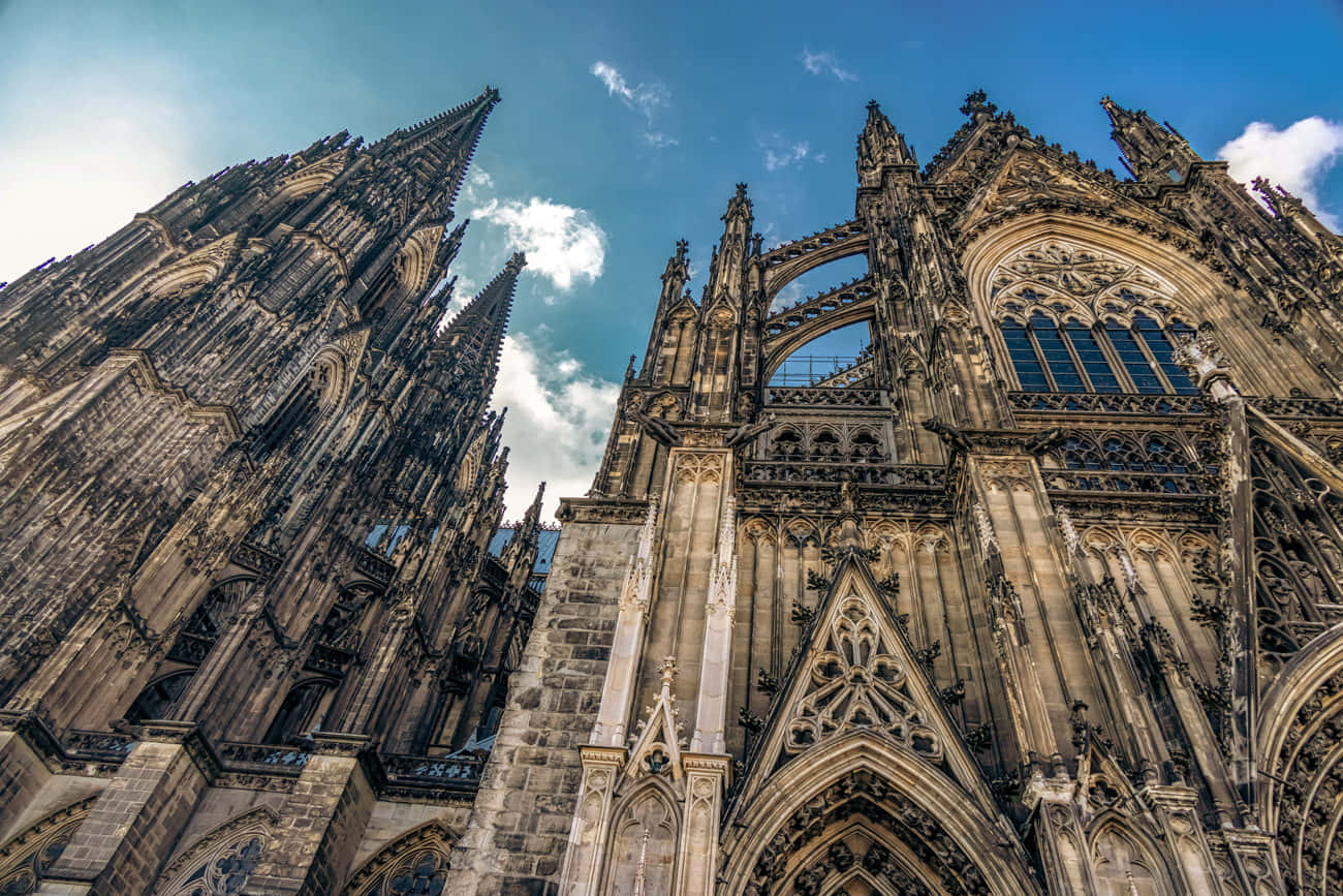 Majestic Gothic Cathedral With Sunlight Peeking Through Wallpaper