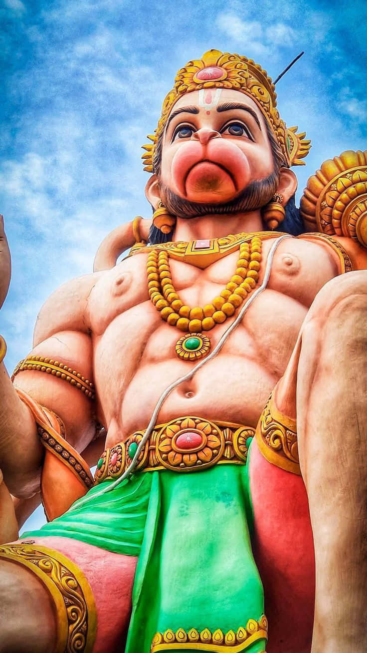 Majestic Hanuman Statue Sky Backdrop Wallpaper