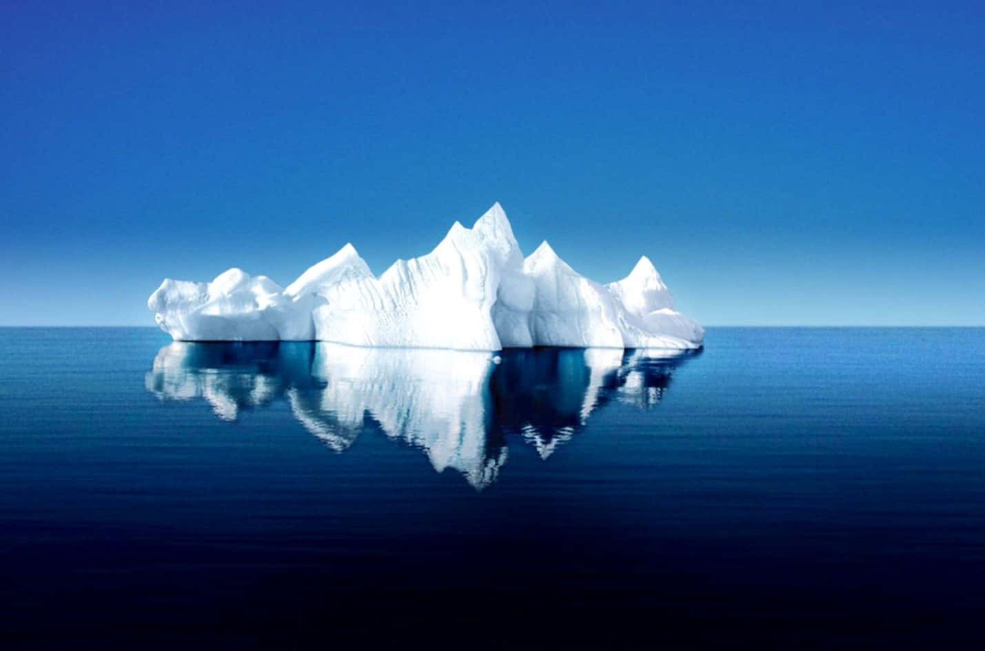 Majestic Iceberg Floating On Tranquil Waters Wallpaper