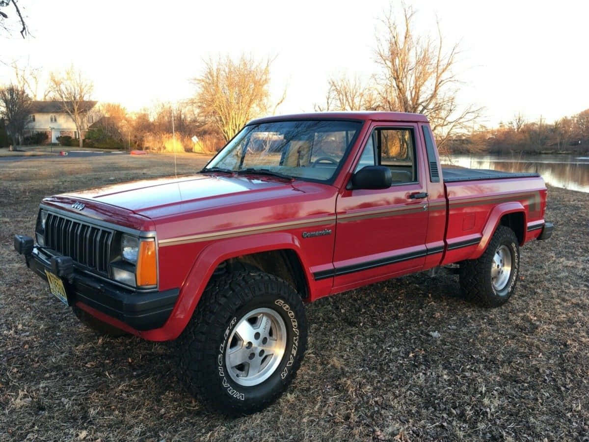 Majestic Jeep Comanche Traversing Rough Terrain In The Great Outdoors Wallpaper