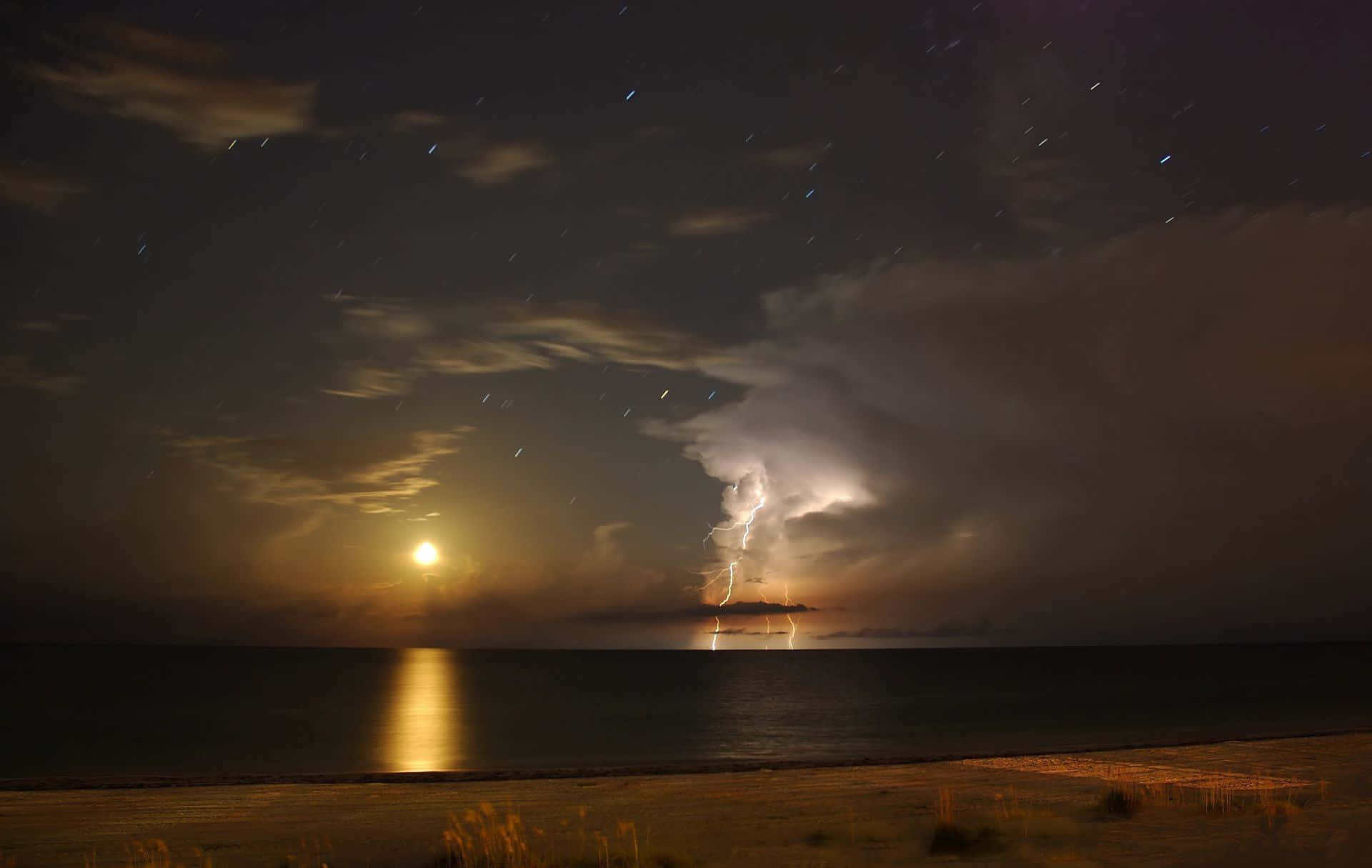 Majestic Lightning Storm Underneath A Full Moon Wallpaper