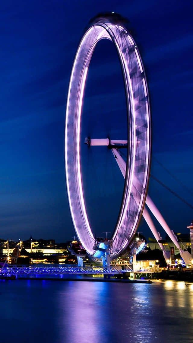 Majestic London Eye Illuminated With Purple Lights Wallpaper