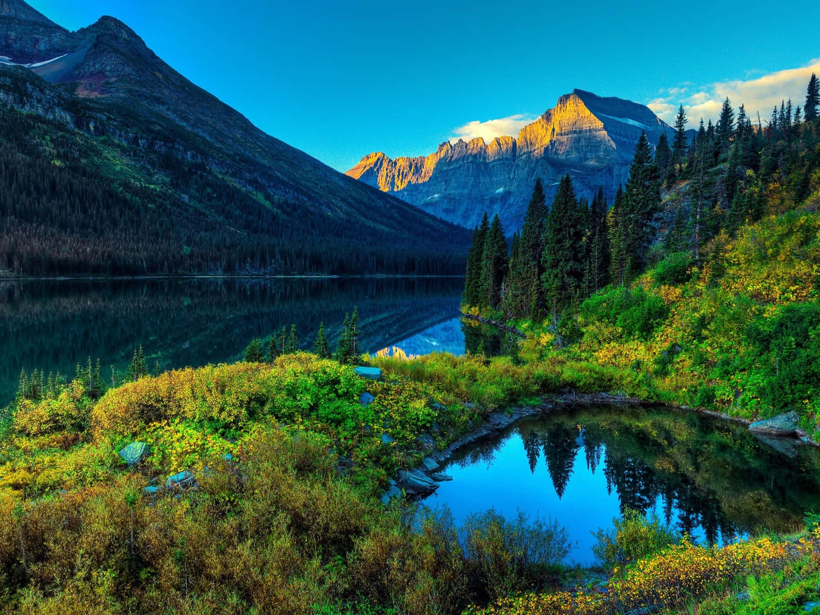 Majestic Mountain Peak Towering Over A Tranquil Valley Wallpaper