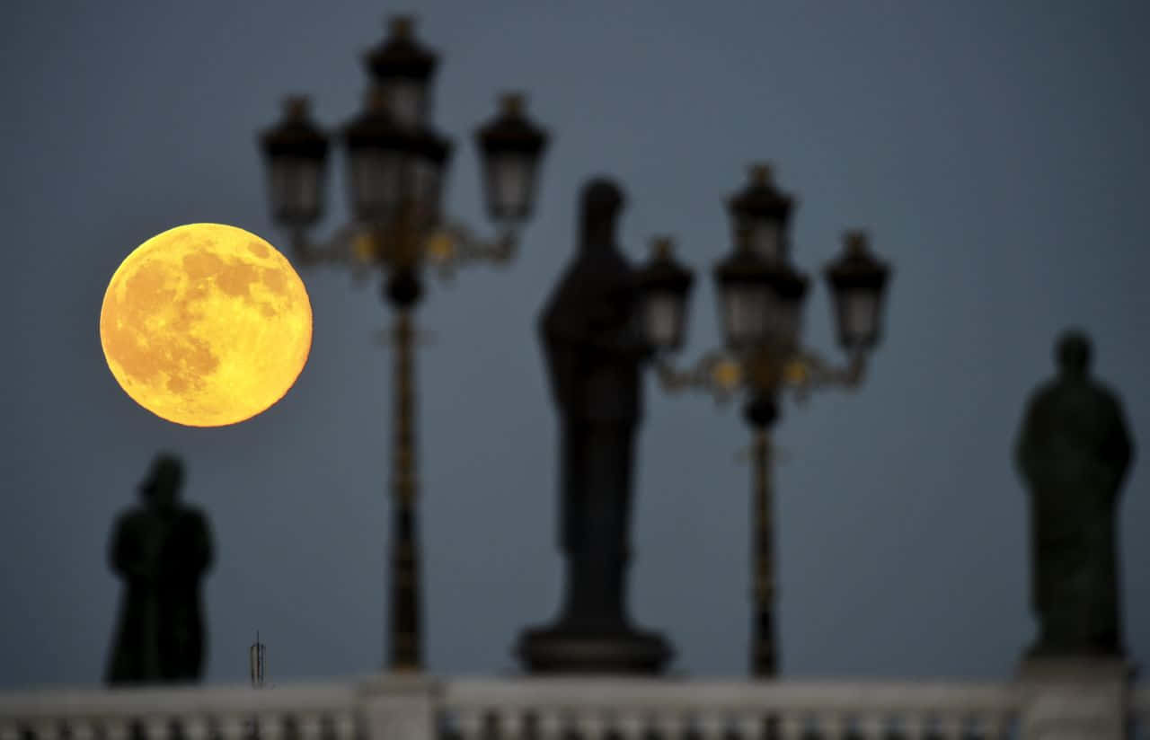 Majestic Perigee Moon Illuminating The Night Sky Wallpaper