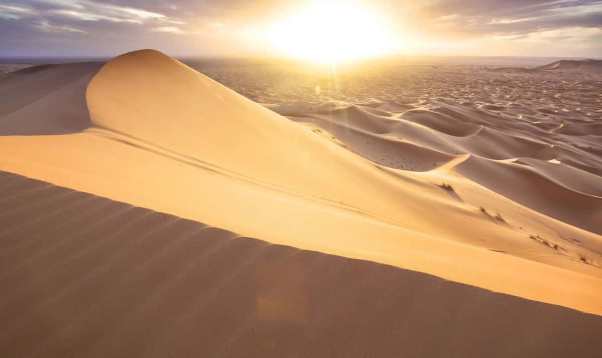 Majestic Sand Dunes Under A Vibrant Sky Wallpaper