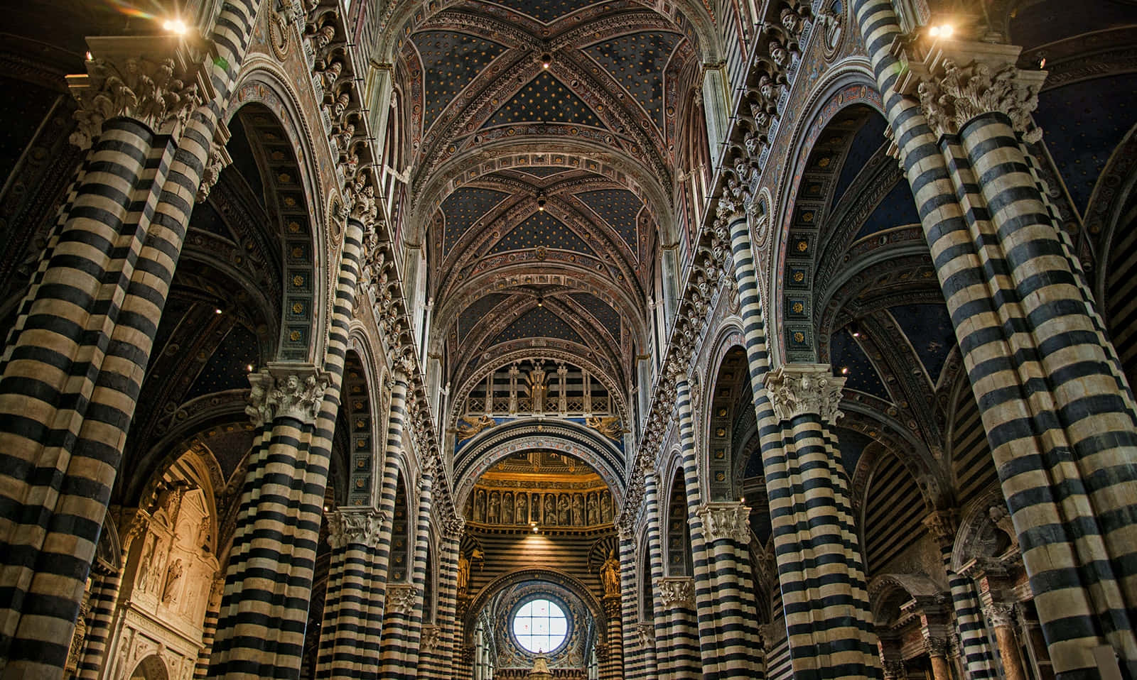 Majestic Siena Cathedral Against Blue Sky Wallpaper