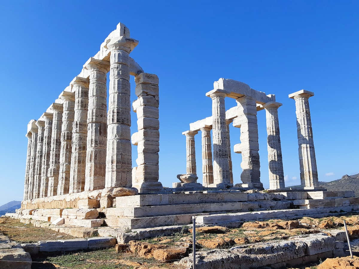 Majestic Temple Of Poseidon Overlooking The Aegean Sea Wallpaper