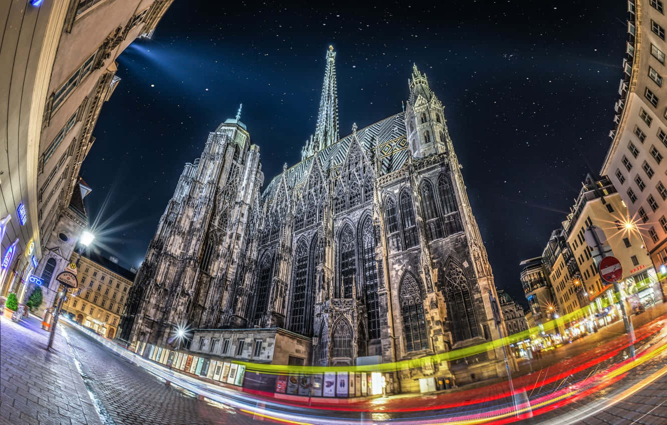 Majestic Vienna Cathedral Against A Beautiful Sunset Sky Wallpaper