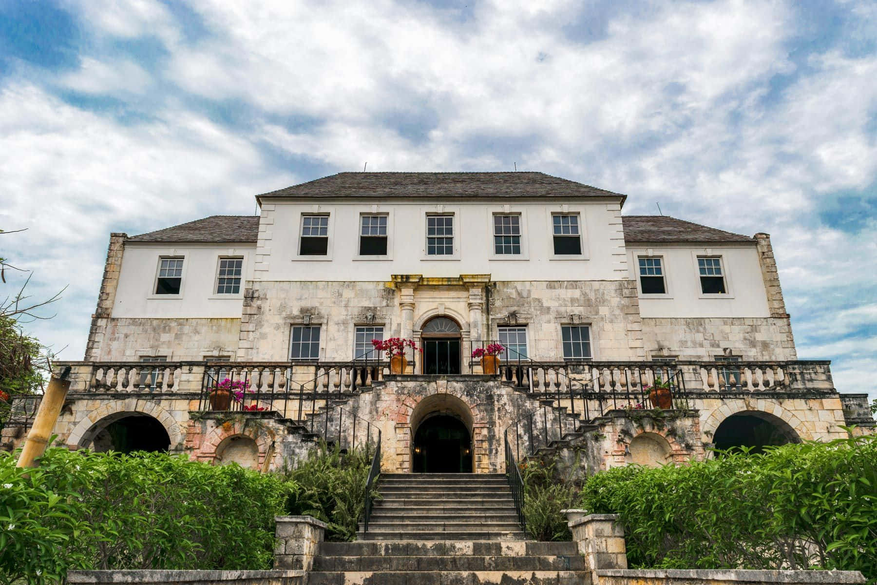 Majestic View Of Rose Hall Great House With A Partially Cloudy Sky Wallpaper