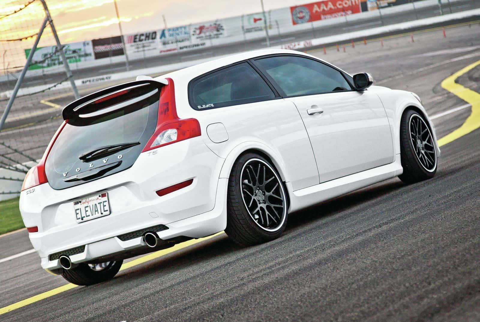 Majestic Volvo C30 Cruising On A Suburban Road Wallpaper