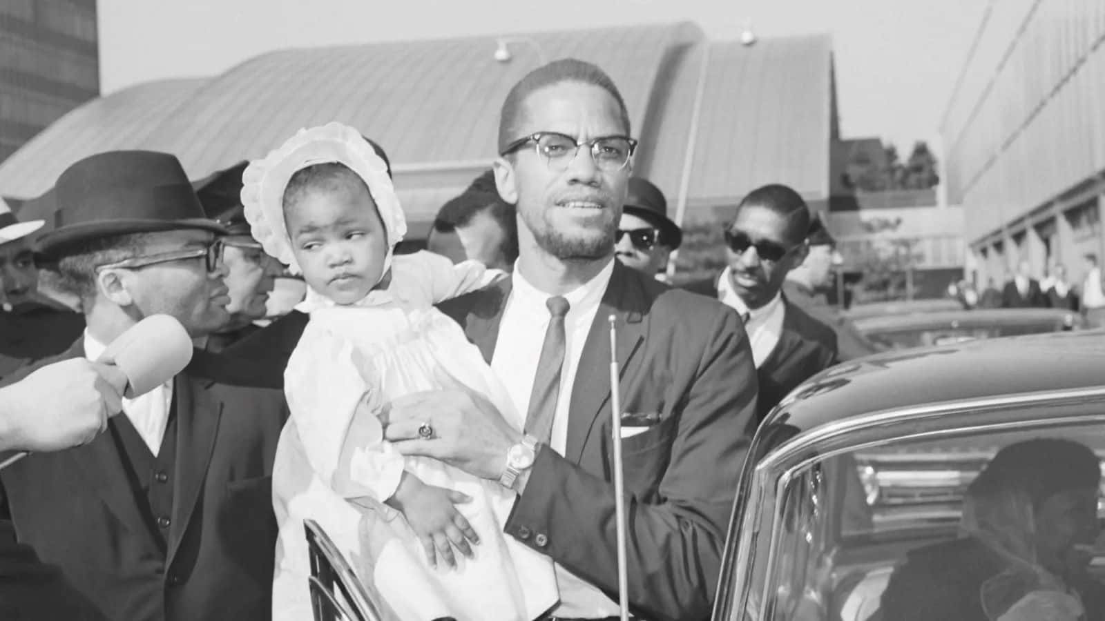 Malcolm_ X_ Holding_ Child Wallpaper