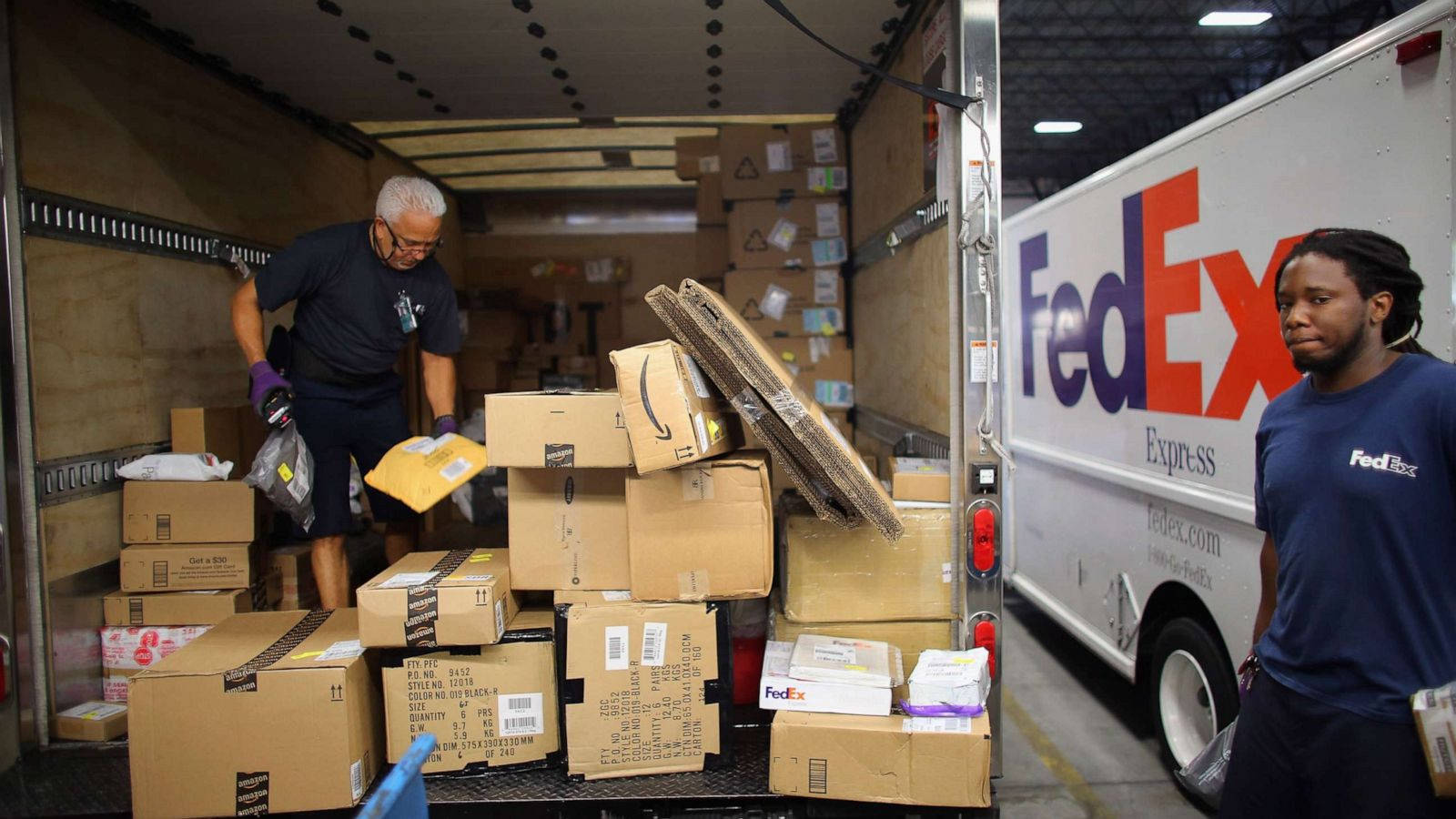 Man Checking Fedex Packages Online Wallpaper