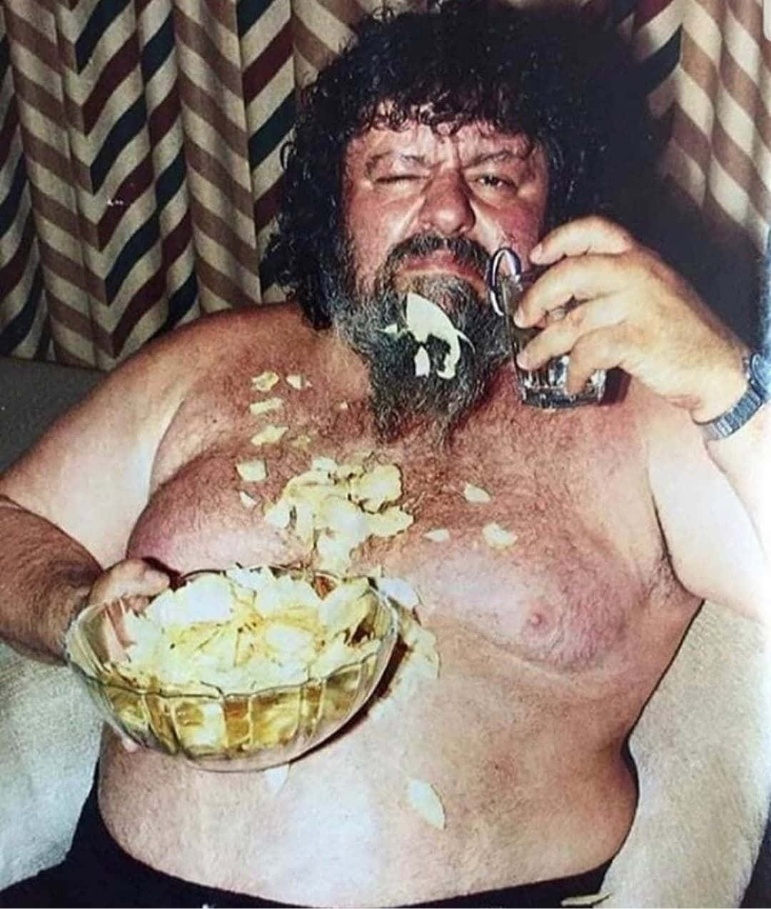 Man Eating Chipsand Drinking Wallpaper