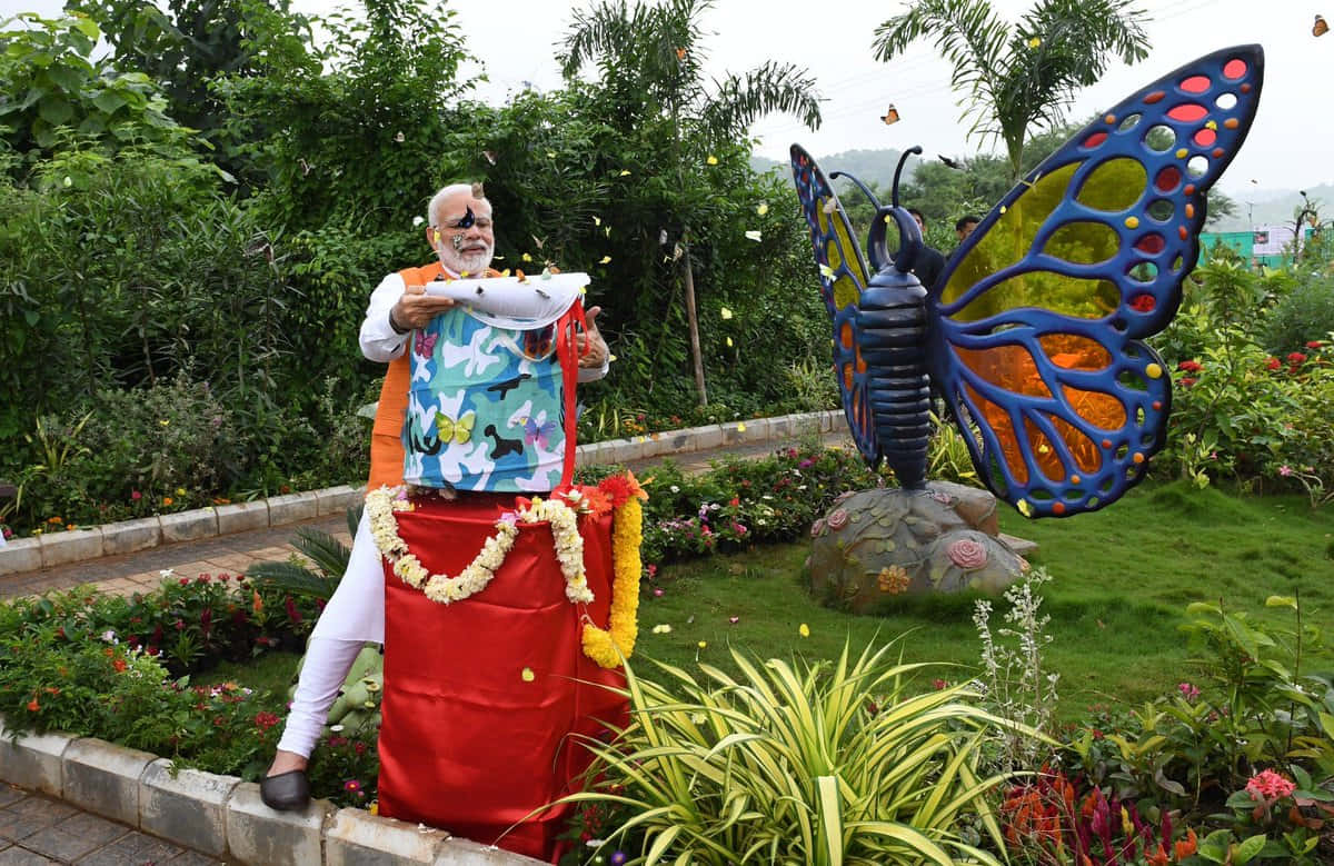 Man Feeding Butterfliesat Park Wallpaper