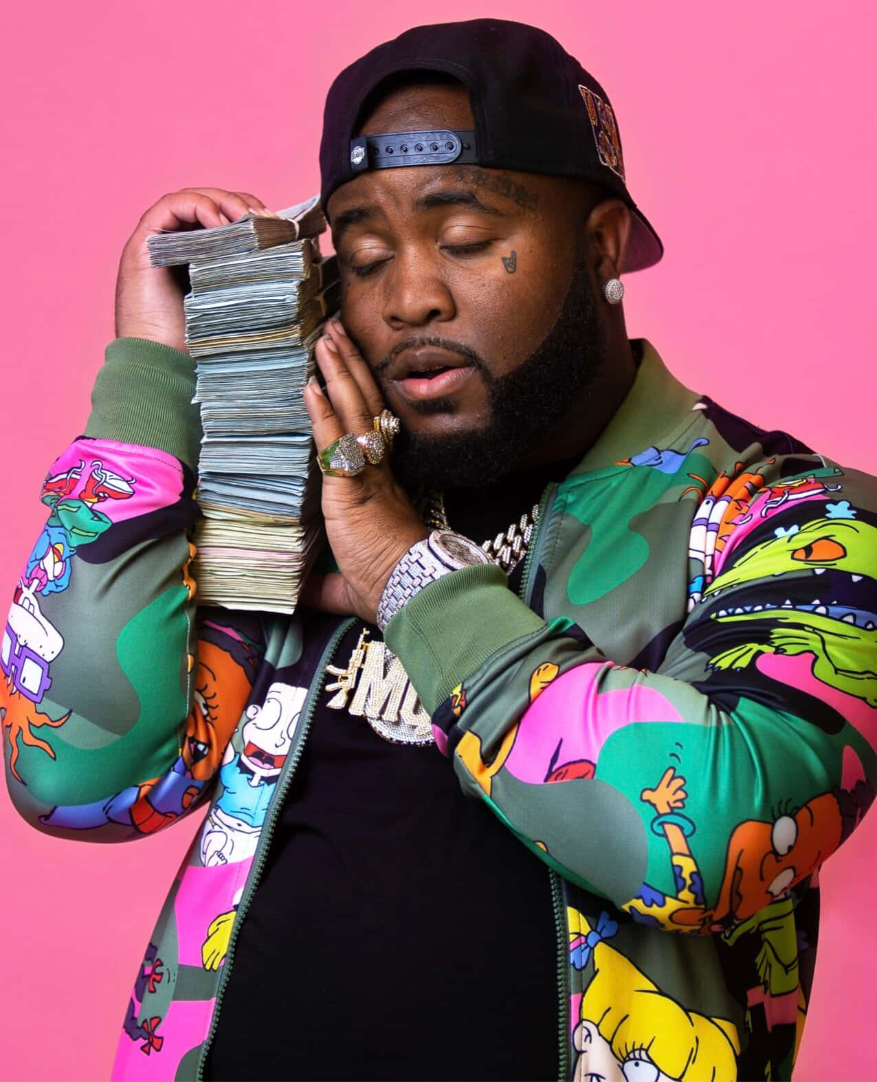 Man Holding Money Stacks Against Pink Background Wallpaper