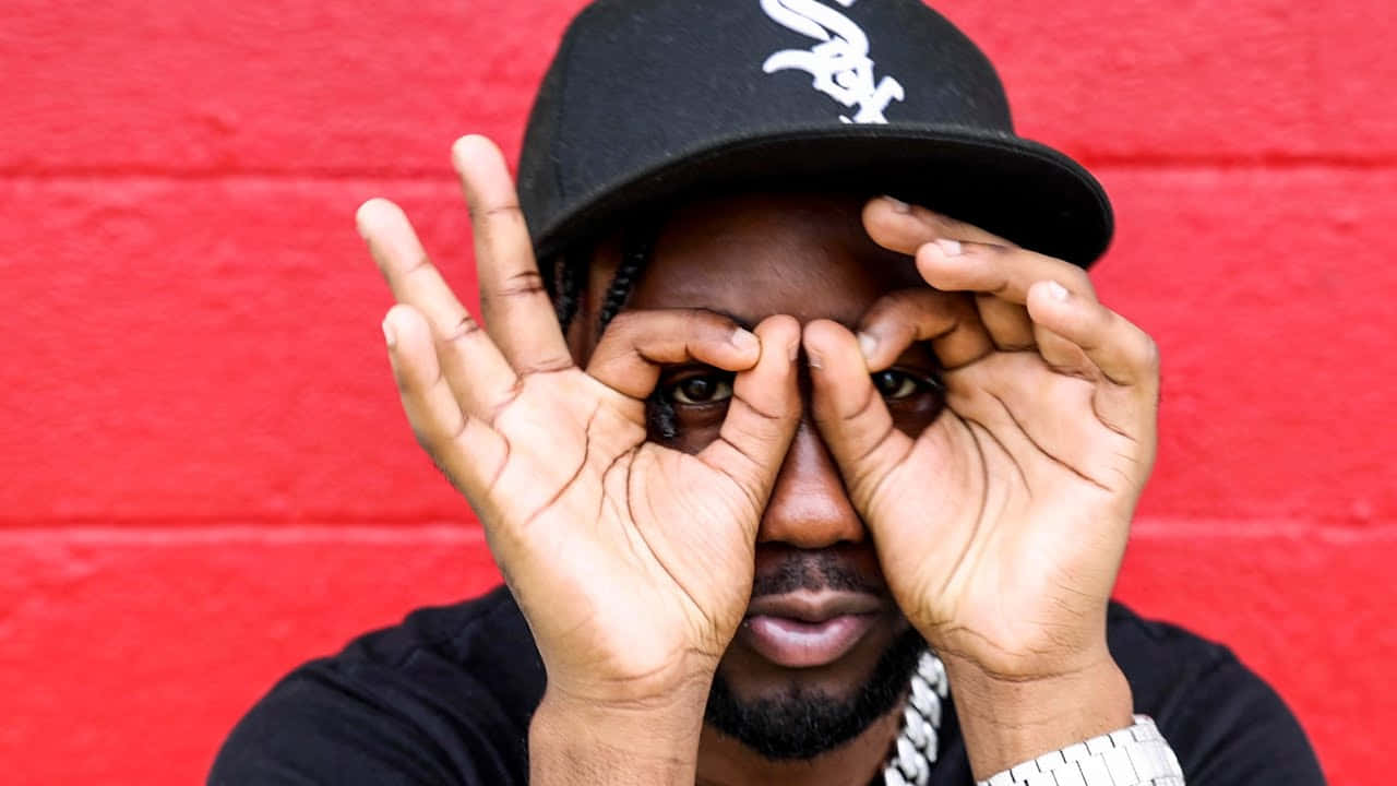 Man Making Hand Goggles Against Red Wall Wallpaper