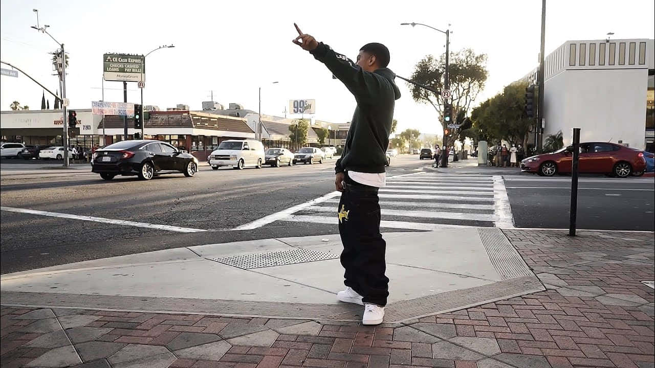 Man Pointing Across Street Wallpaper