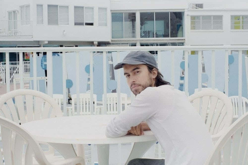 Man Seaside Balcony Contemplation.jpg Wallpaper