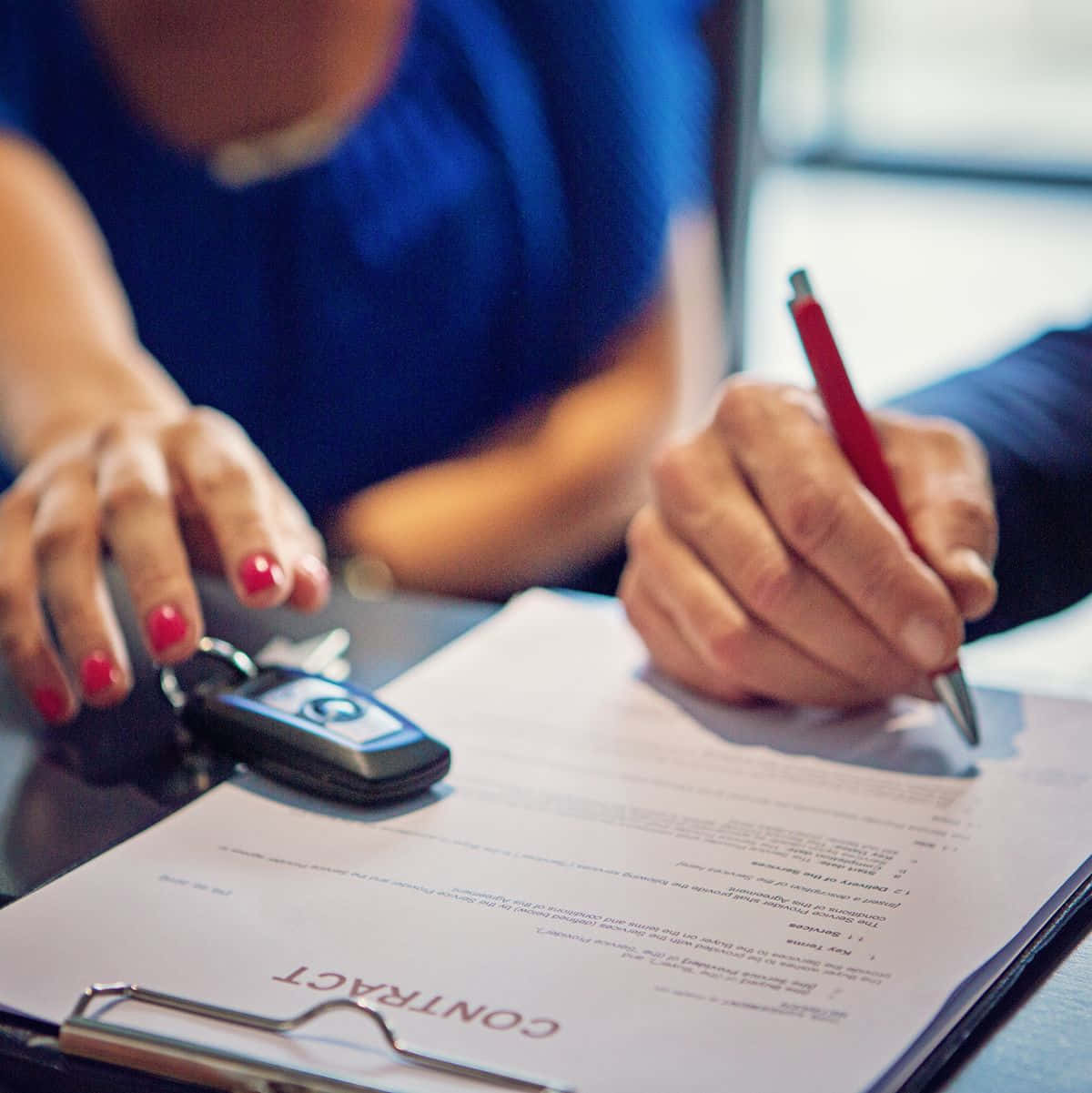 Man Signing A Car Purchase Agreement Wallpaper