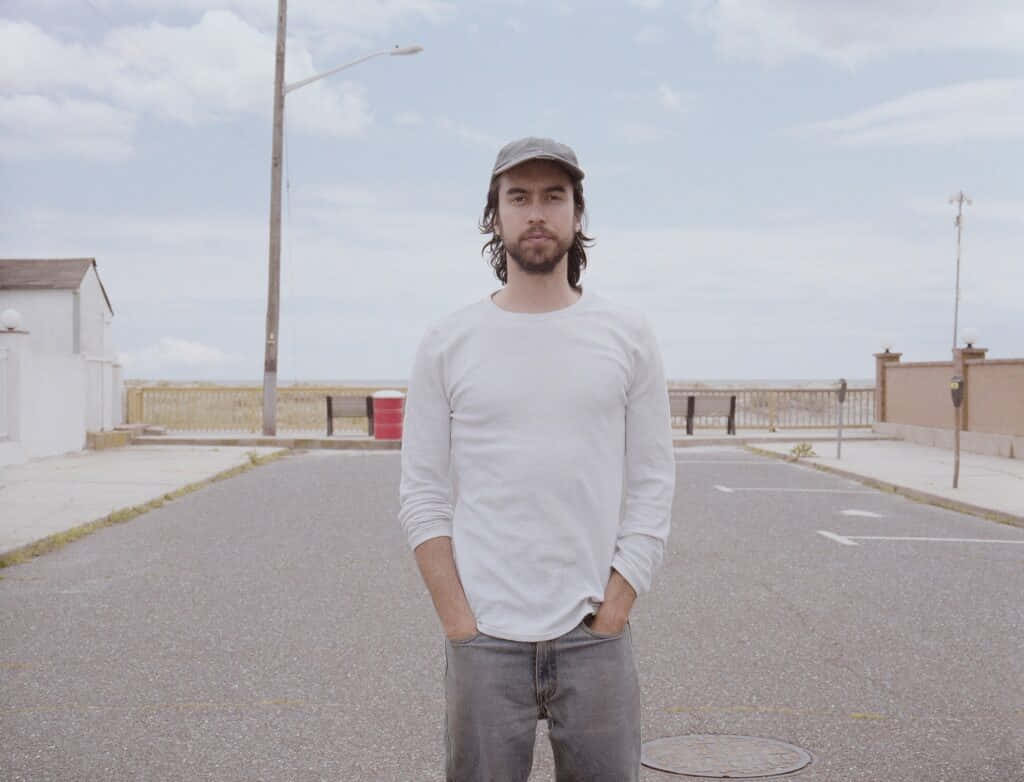 Man Standingin Desolate Street Wallpaper