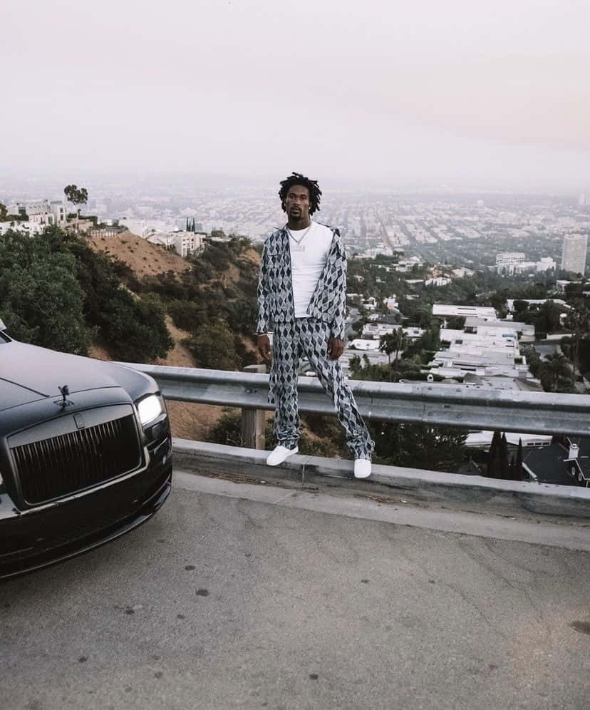 Man With Car Overlooking City Wallpaper