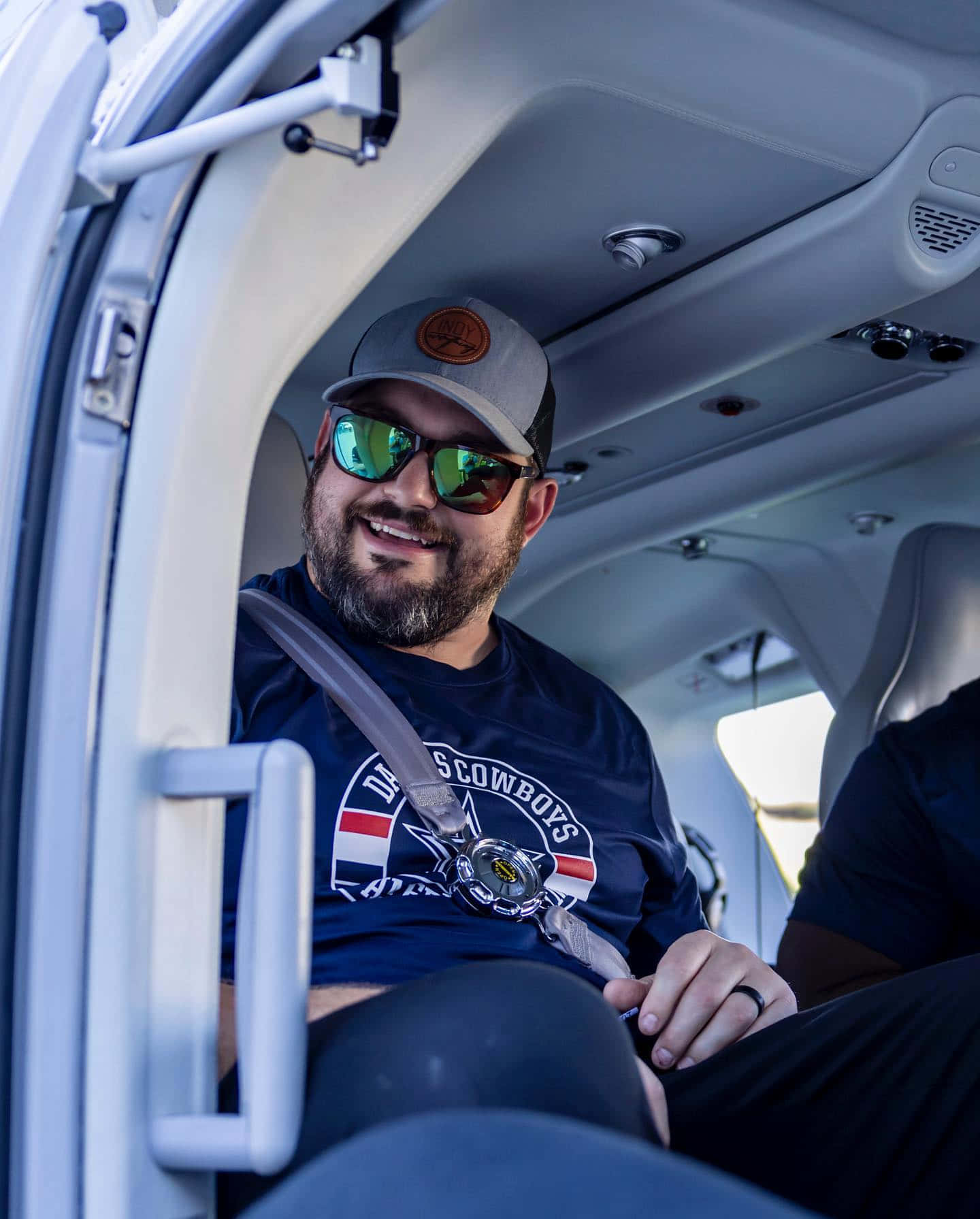 Manin Cap Smiling Aboard Aircraft Wallpaper