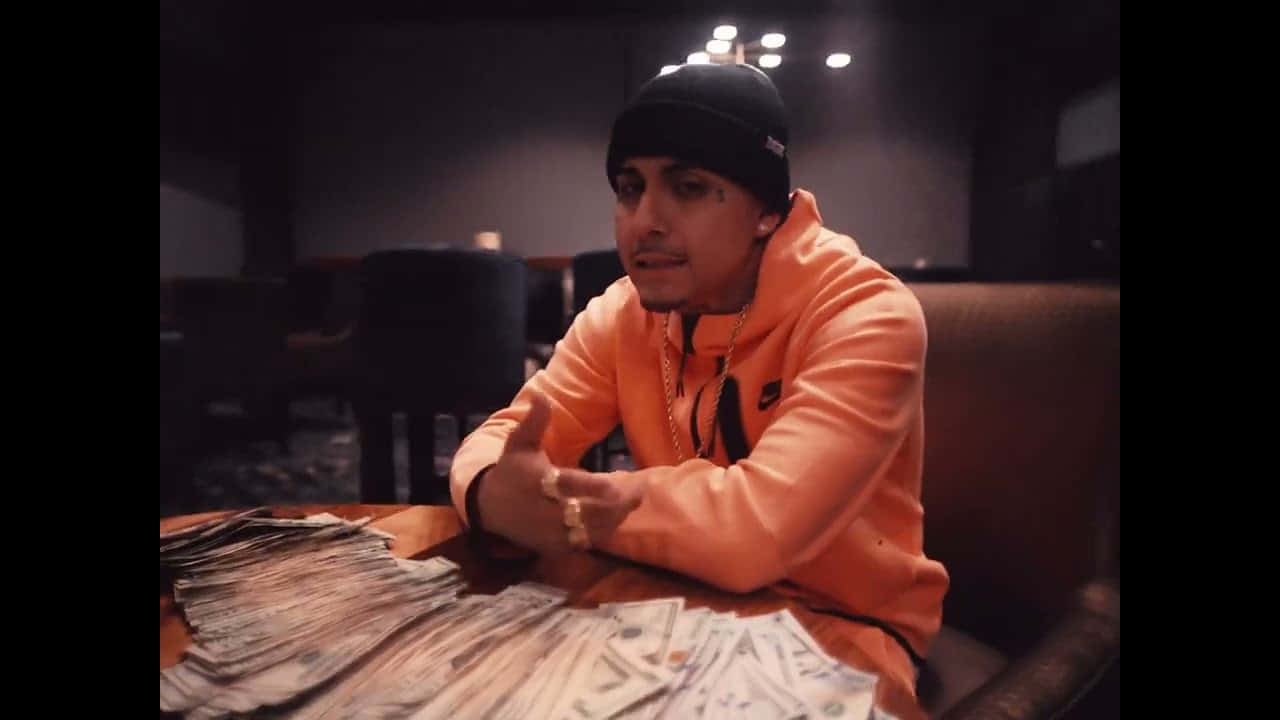 Manin Orange Hoodiewith Cashon Table.jpg Wallpaper