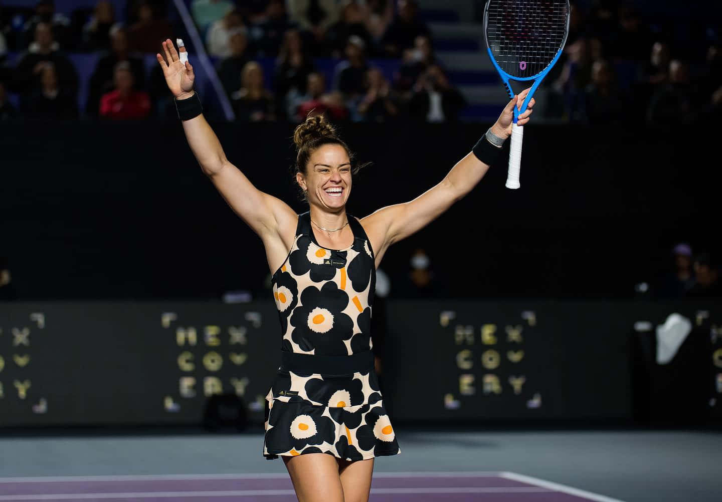 Maria Sakkari Smiling With Arms Raised Wallpaper