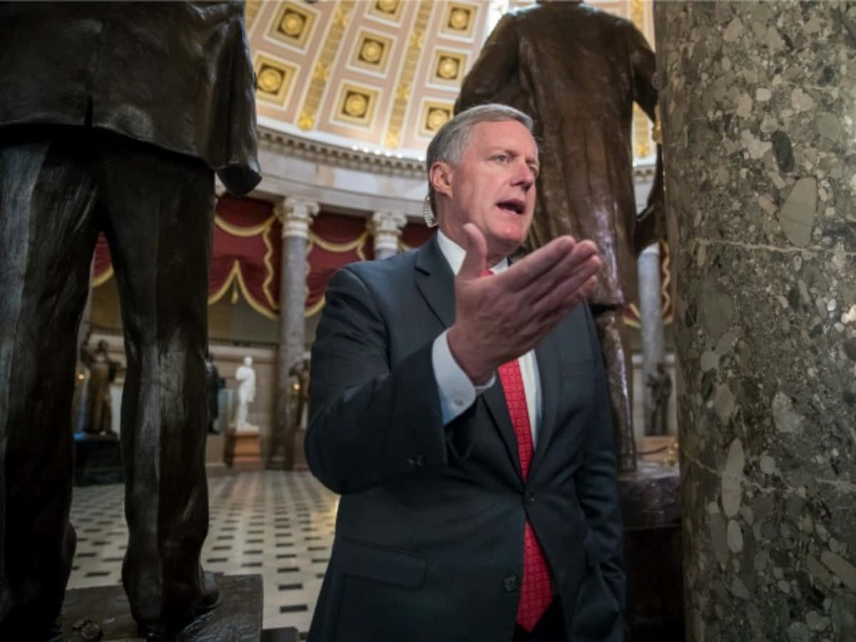 Mark Meadows Speaking Near Statue Wallpaper