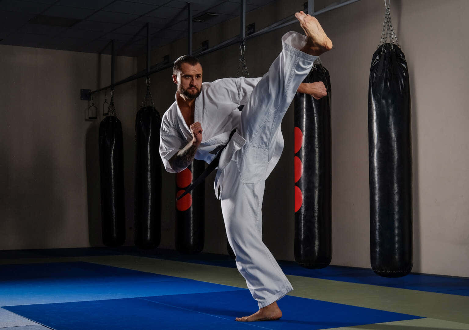 Martial Arts Expert Practicing Moves In Traditional Uniform Wallpaper