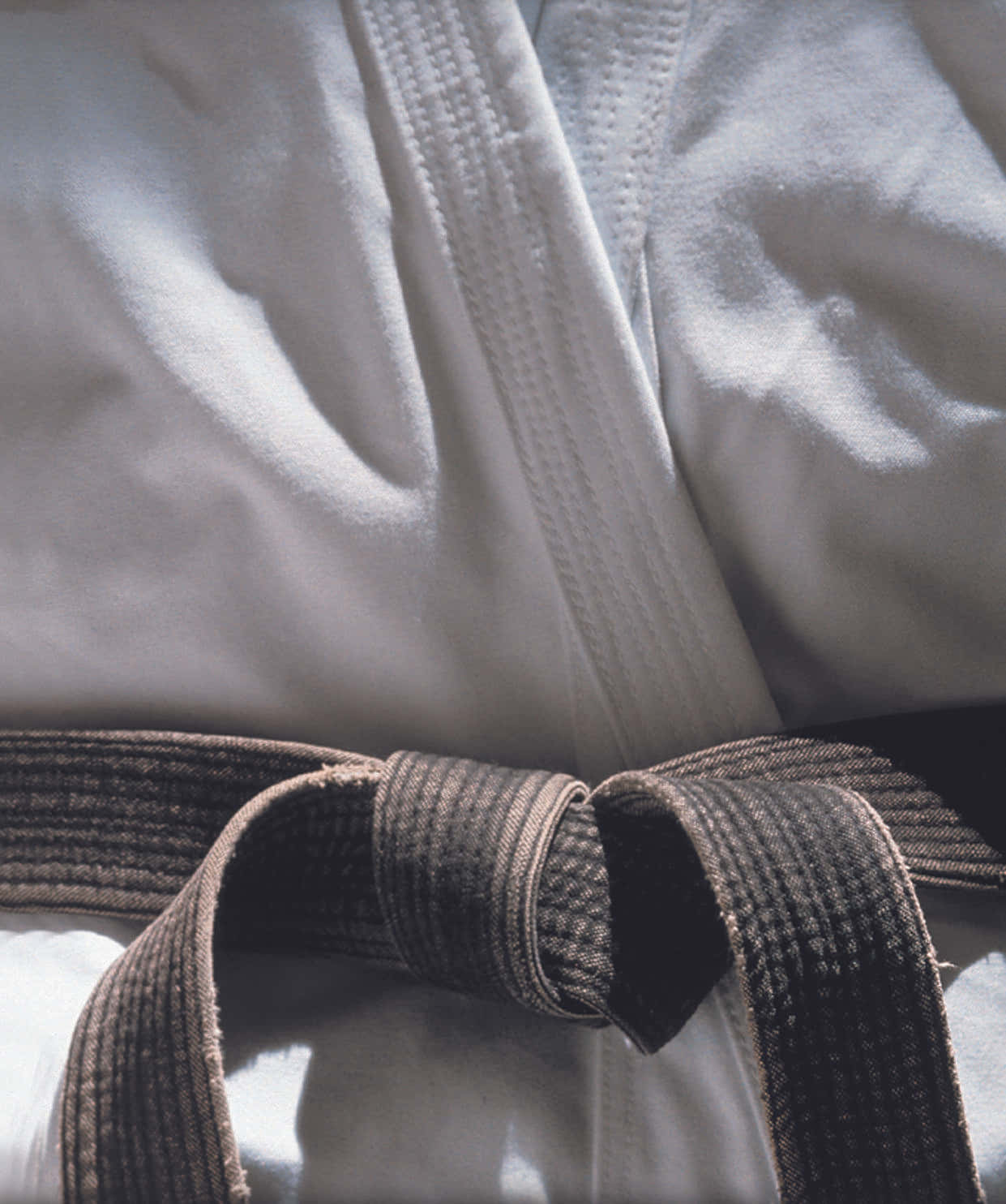 Martial Arts Master Wearing A Traditional Gi And Black Belt Wallpaper