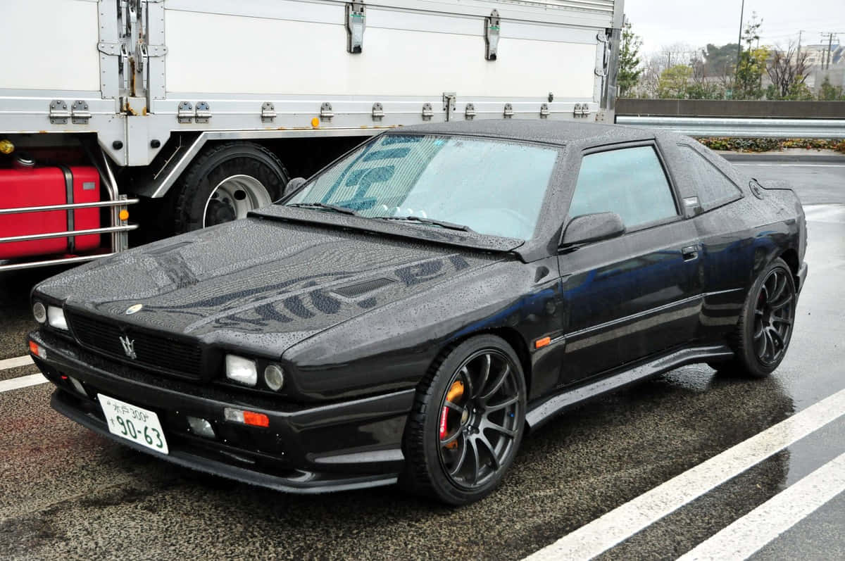 Maserati Shamal Parked Beside Truck Wallpaper