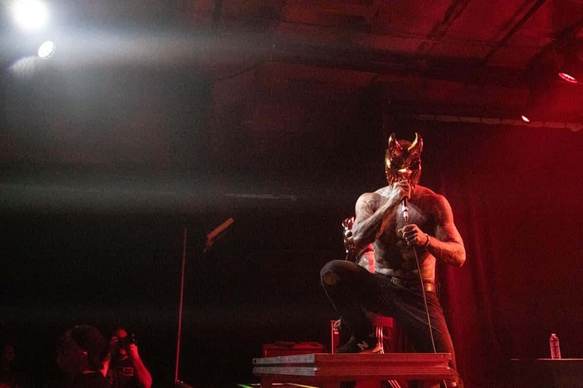 Masked_ Metal_ Performer_on_ Stage.jpg Wallpaper