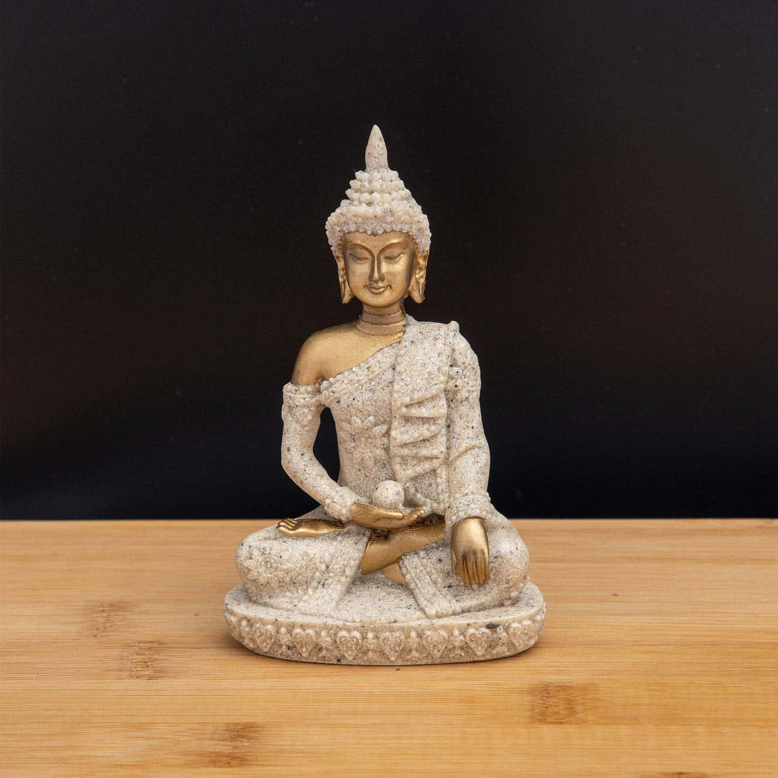 Meditating Buddha Statueon Wooden Table Wallpaper