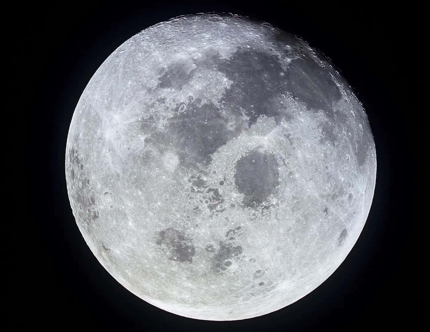 Mesmerizing Moon Craters Illuminated Against A Star-studded Sky Wallpaper