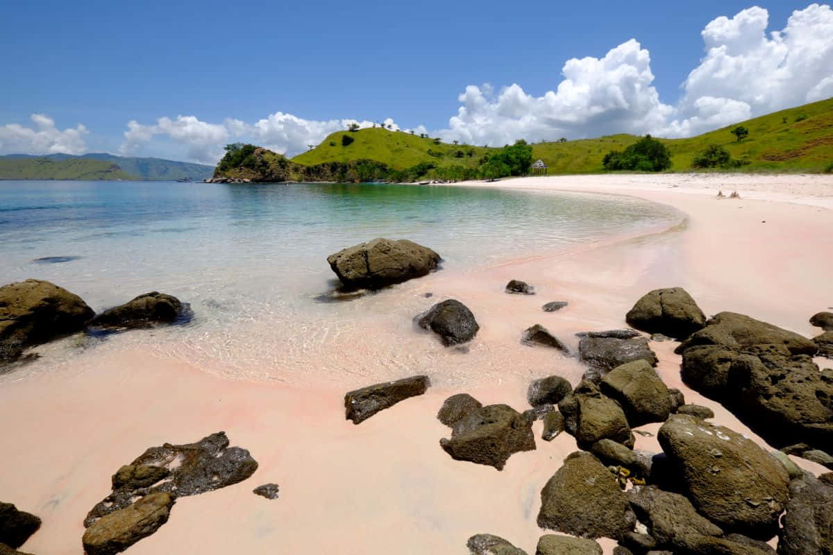 Mesmerizing Pink Sand Beach At Sunset Wallpaper