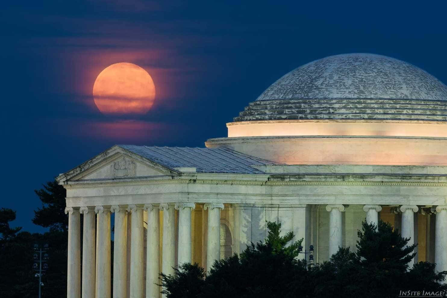 Mesmerizing Strawberry Moon In A Clear Night Sky Wallpaper