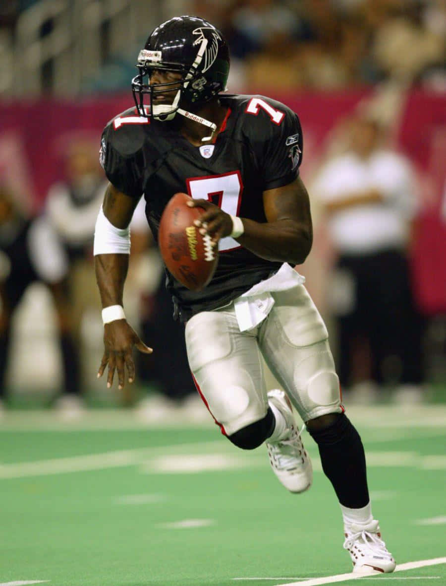 Michael Vick In Action During The 2004 Nfl Season Wallpaper