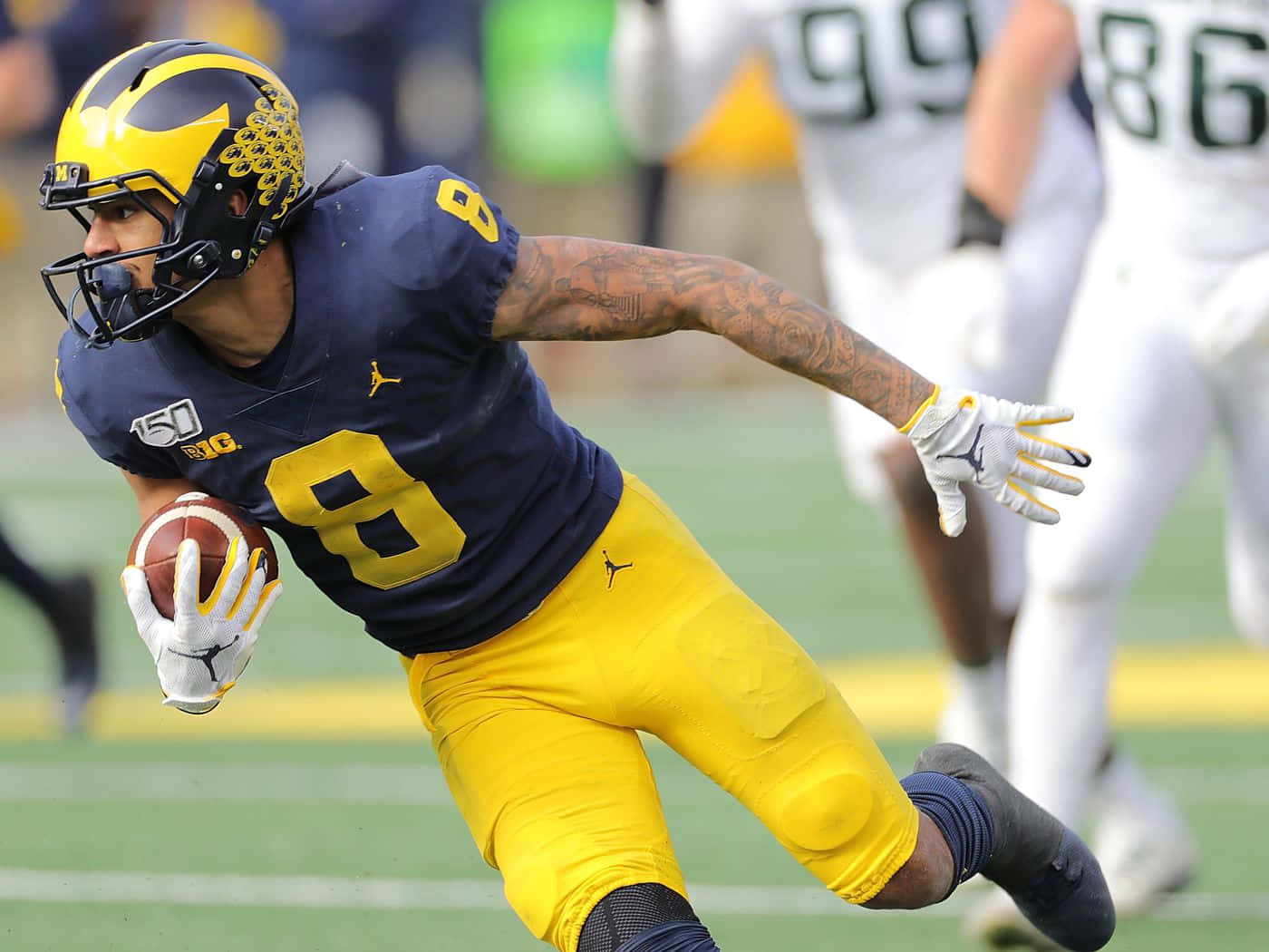 Michigan Football Player Running With Ball Wallpaper