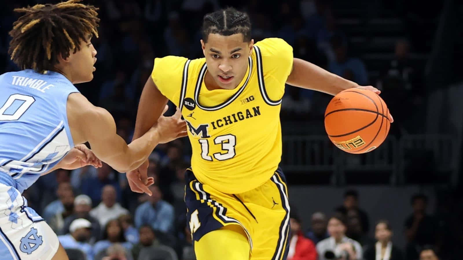 Michigan Player Dribbling Past Opponent Wallpaper