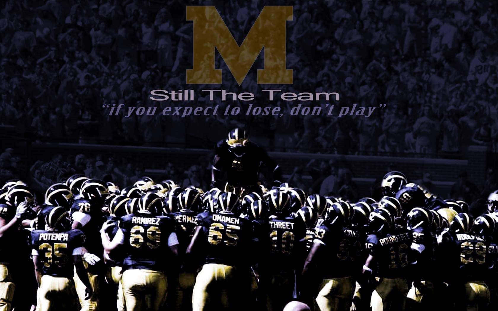 Michigan Wolverines Football Team Charging On The Field Wallpaper