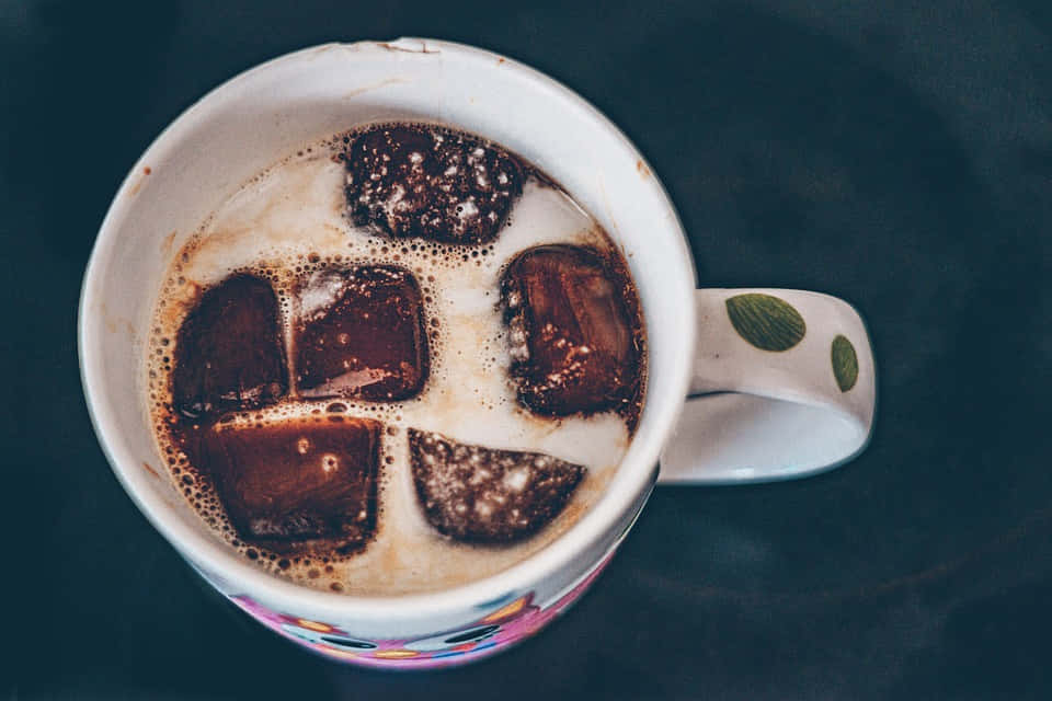 Milk Swirling Into A Cup Of Coffee Wallpaper