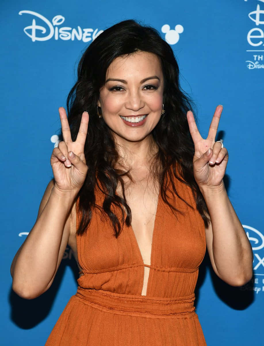 Ming Na Wen Striking A Pose In An Elegant Dress Wallpaper