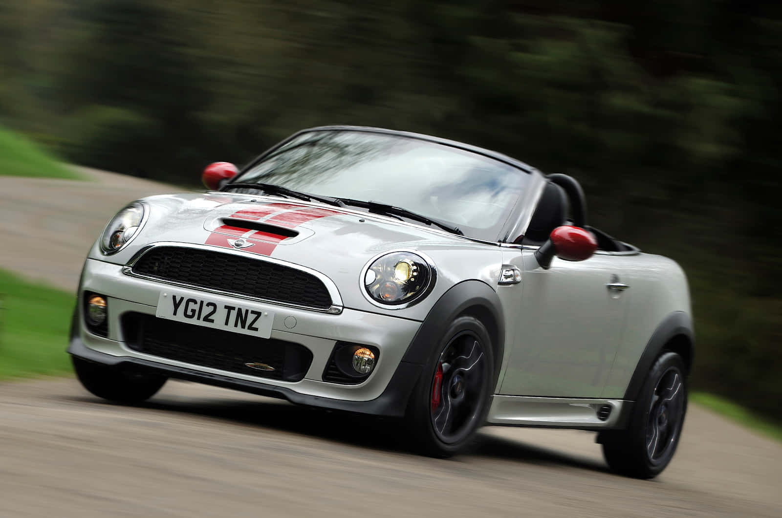 Mini Roadster Speedingon Country Road Wallpaper