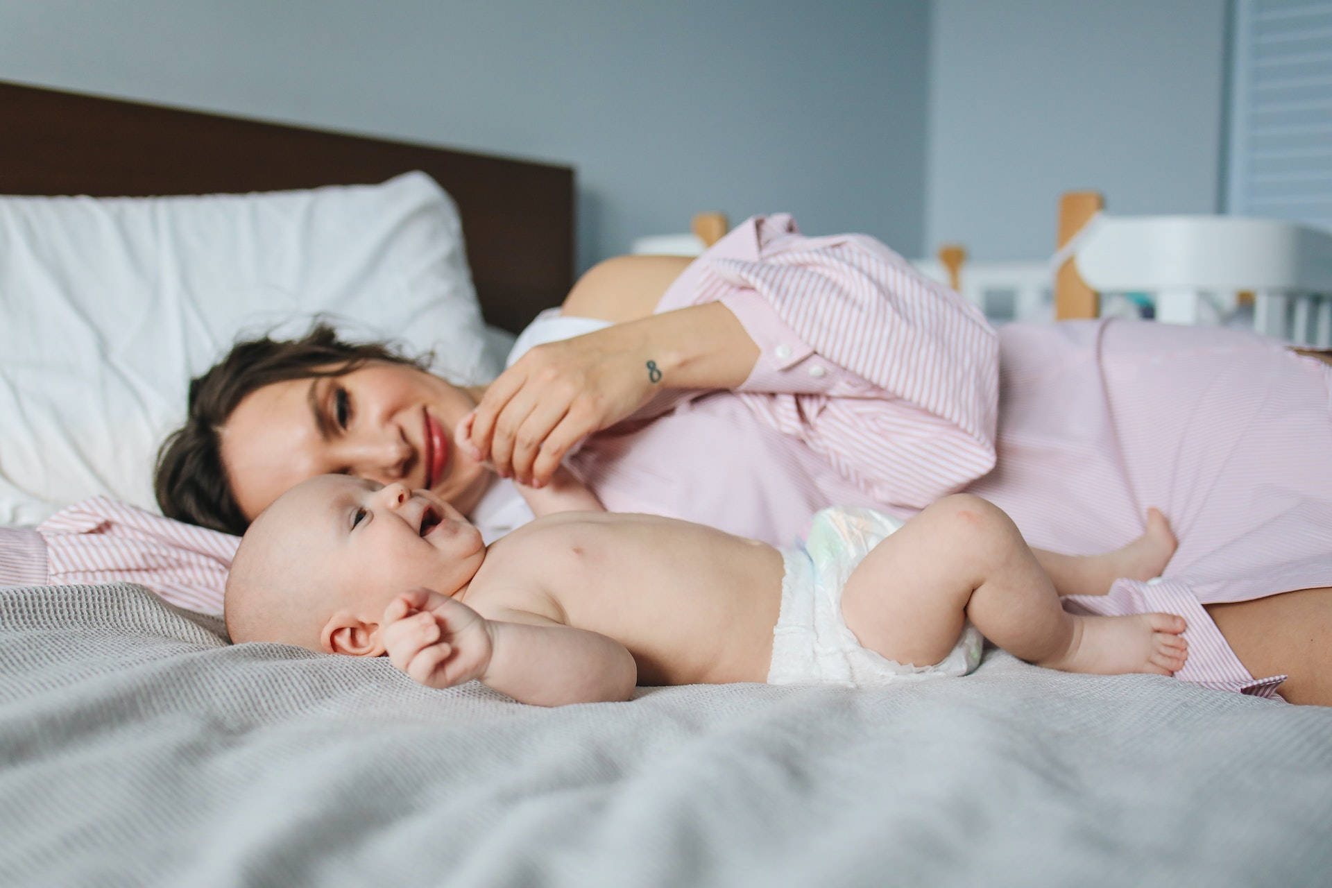 Mother Lying In Bed With Baby Love Wallpaper