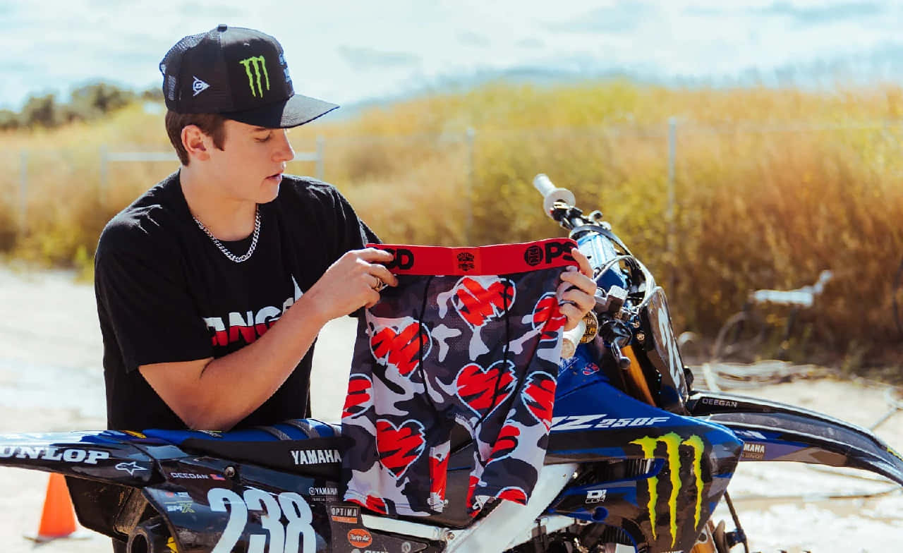 Motocross Rider Prepares Gear Wallpaper