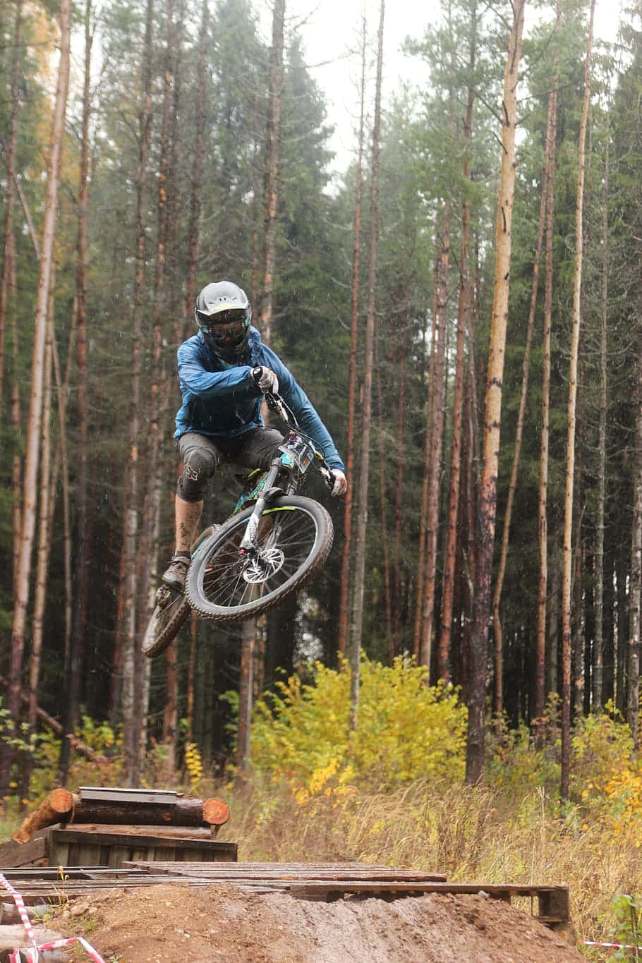 Mountain Biker Aerial Jump Forest Trail.jpg Wallpaper